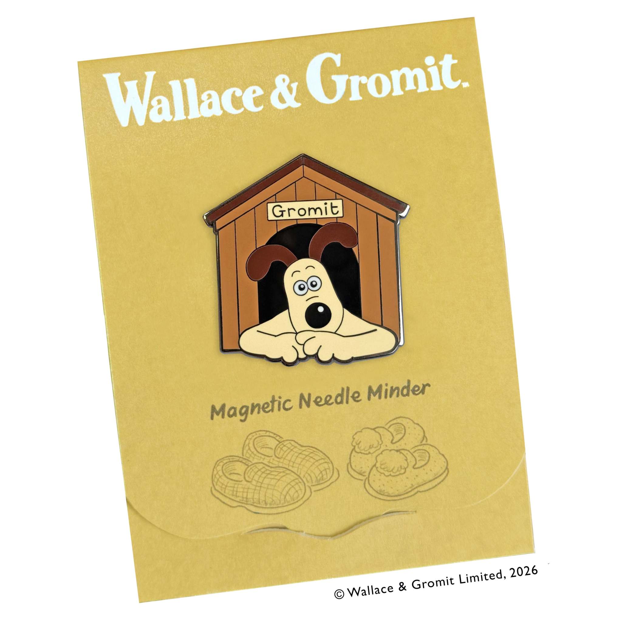 Magnetic needle minder with dog design holding needle and chart on fabric