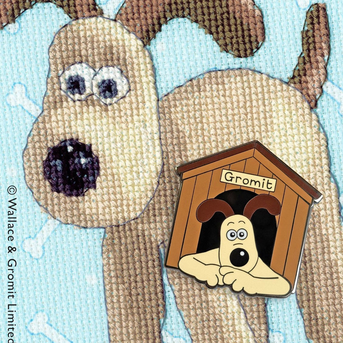 Magnetic Needle Minder with dog design holding needle and chart on fabric