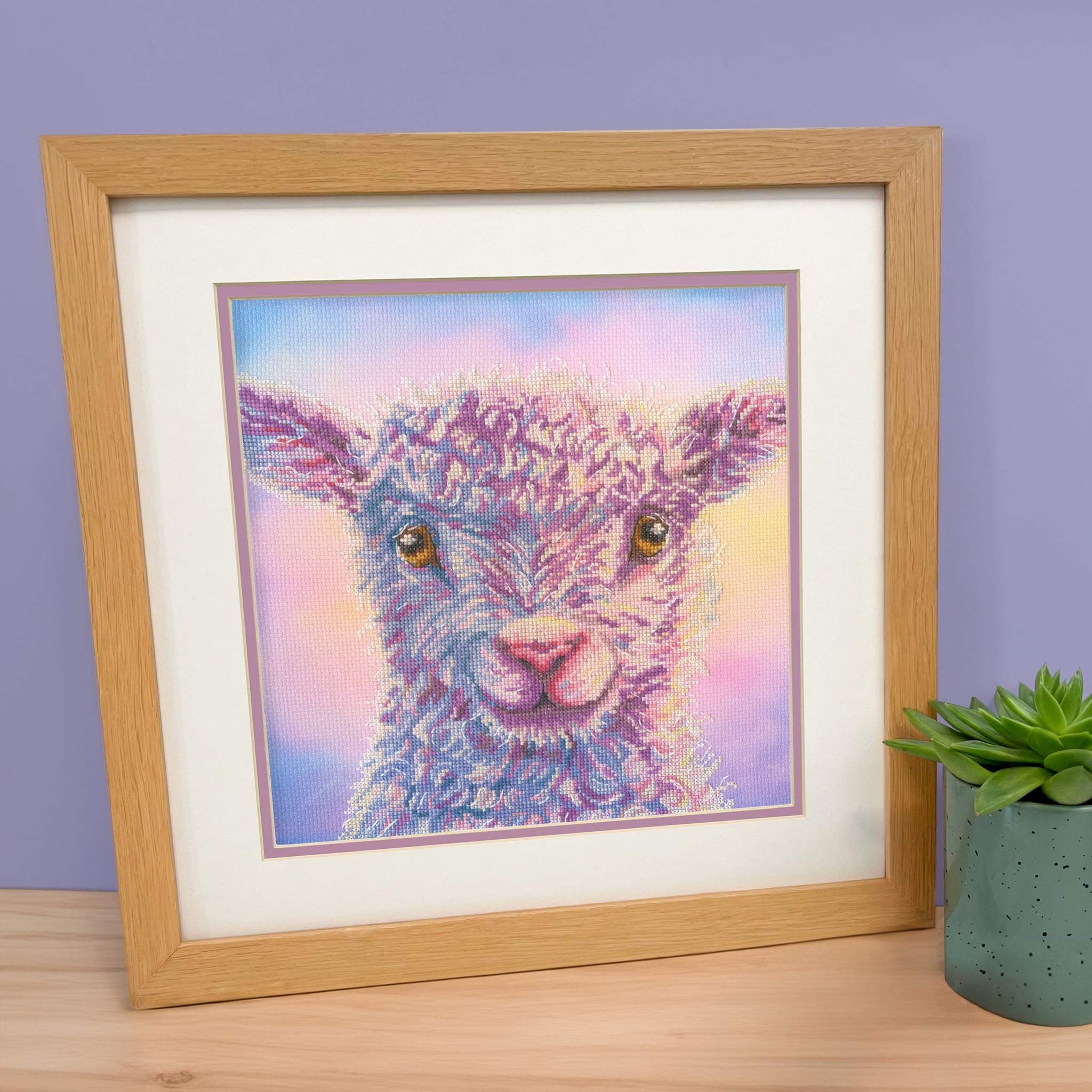 Playful Lamb cross stitch kit with 14 count Aida fabric, stranded cottons, needle, and instructions