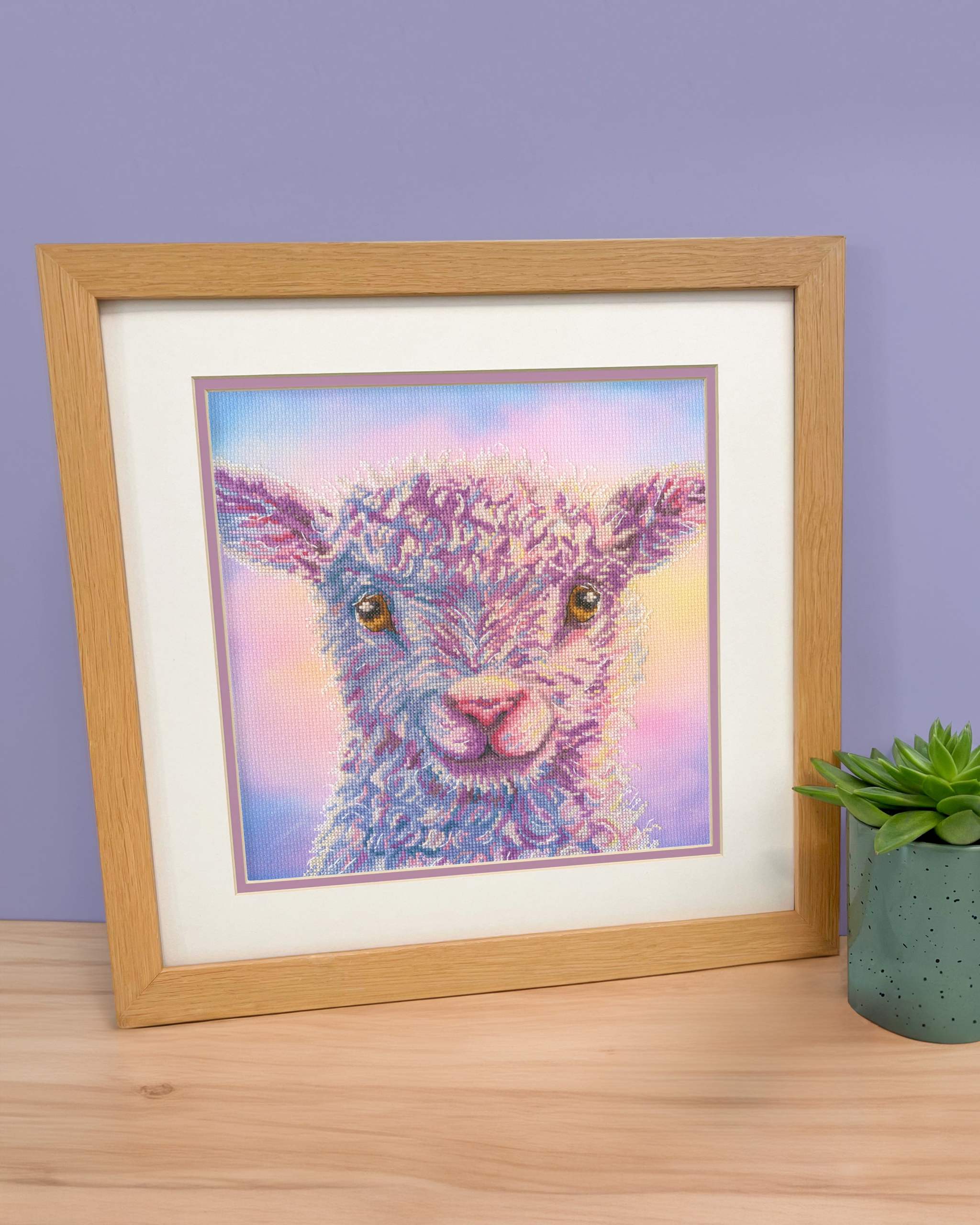 Playful Lamb cross stitch kit with 14 count Aida fabric, stranded cottons, needle, and instructions