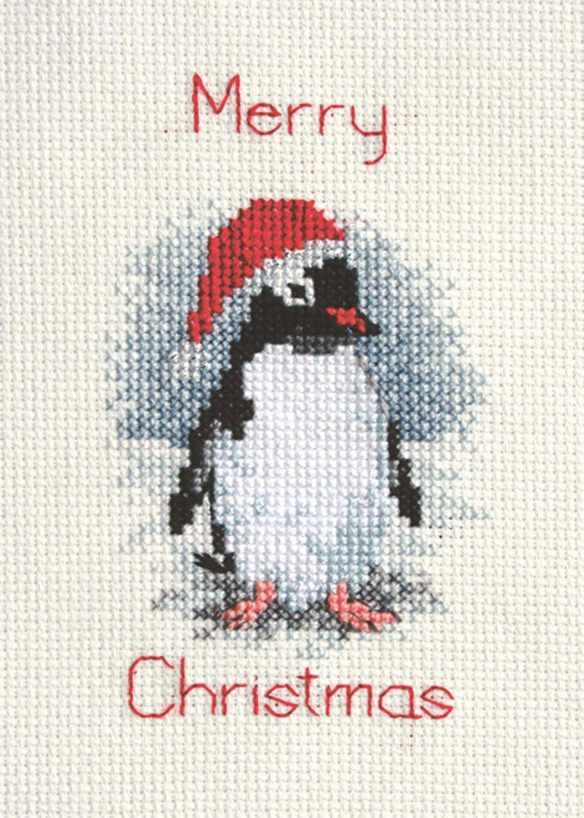 Christmas card cross stitch kit featuring a penguin wearing a Santa hat with "Merry Christmas" text on antique white aida fabric