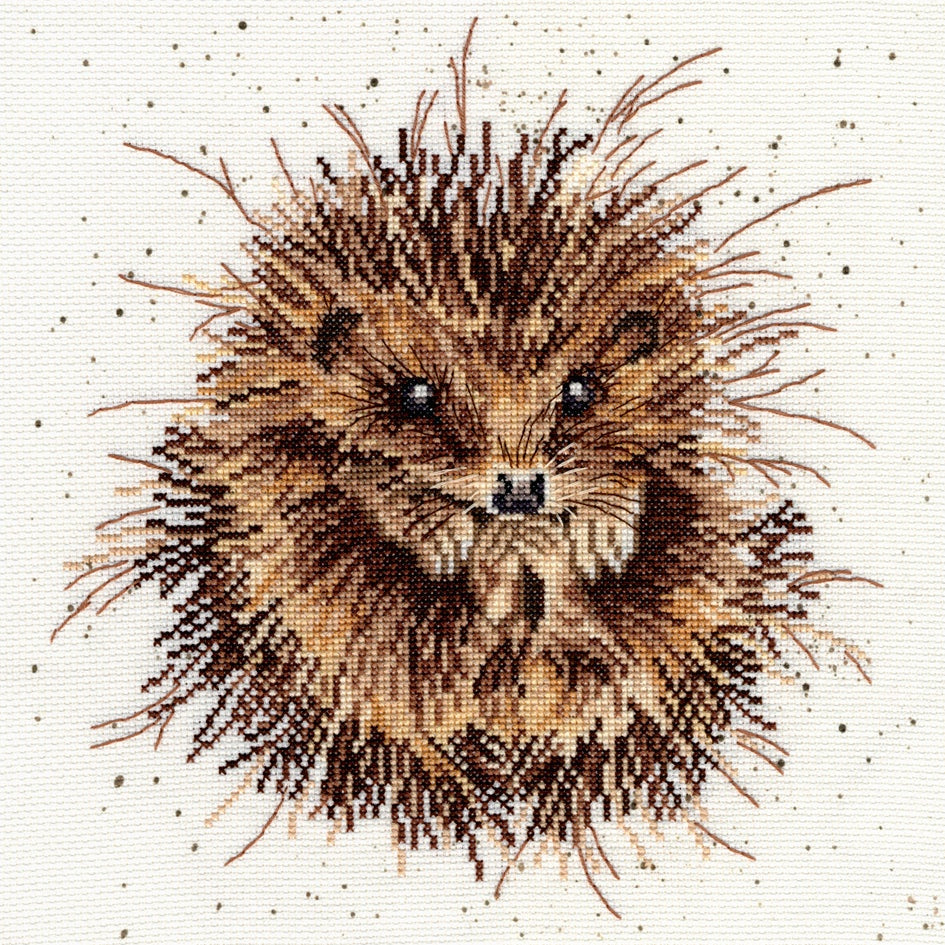 Close-up of a detailed brown hedgehog cross stitch on speckled fabric from the Awakening Cross Stitch Kit gift set