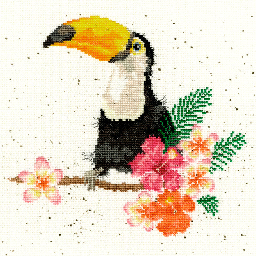 Cross stitch kit featuring toucan on flowery branch with vibrant colors and speckled Aida fabric background