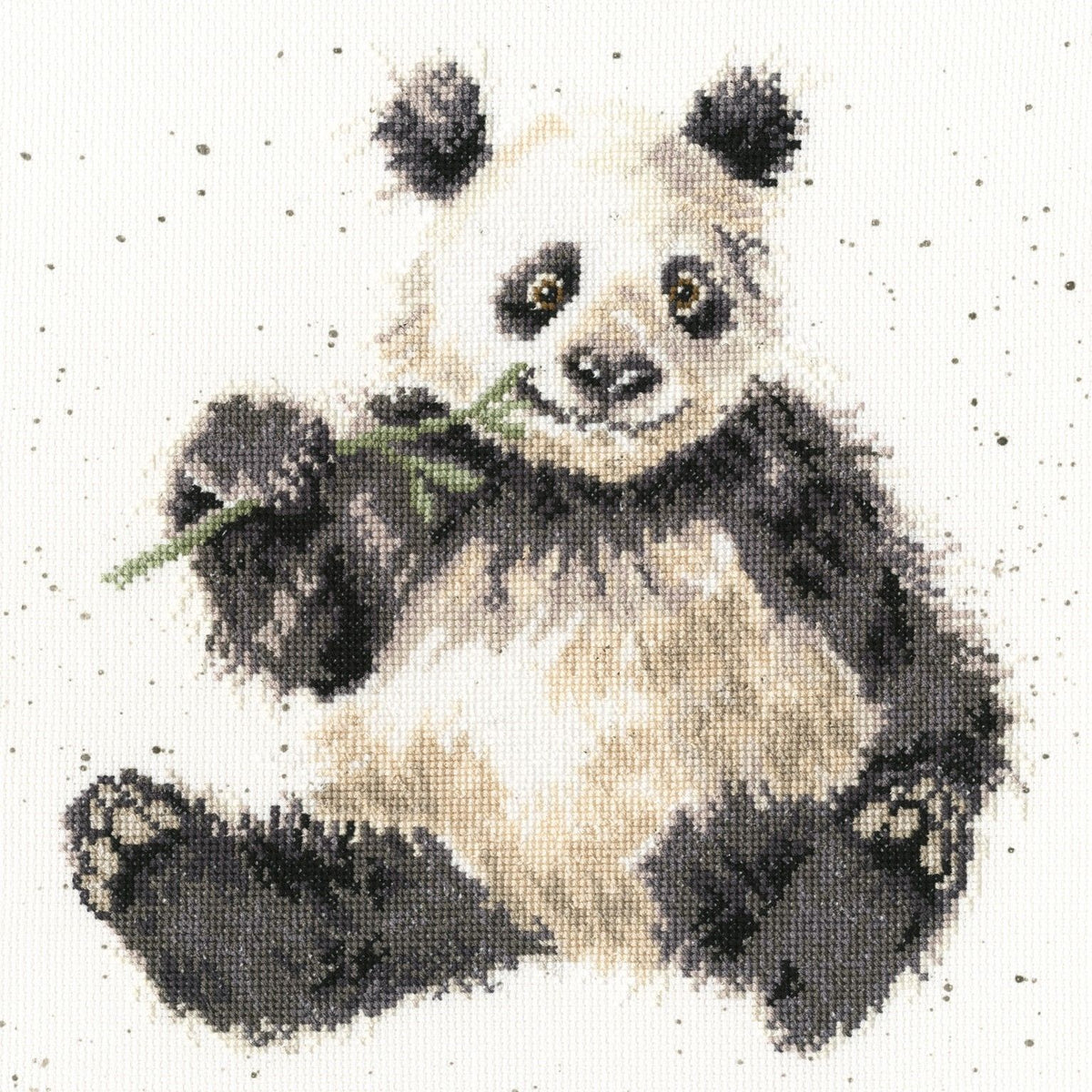 Bamboozled Cross Stitch Kit featuring a cute panda eating bamboo with speckled background on 14 count Aida fabric