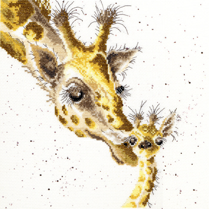 First Kiss Cross Stitch of mother giraffe kissing calf with speckled background detailed embroidery
