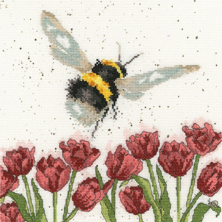 Flight of the Bumblebee cross stitch kit featuring a bee flying over red tulips with speckled background by Bothy Threads