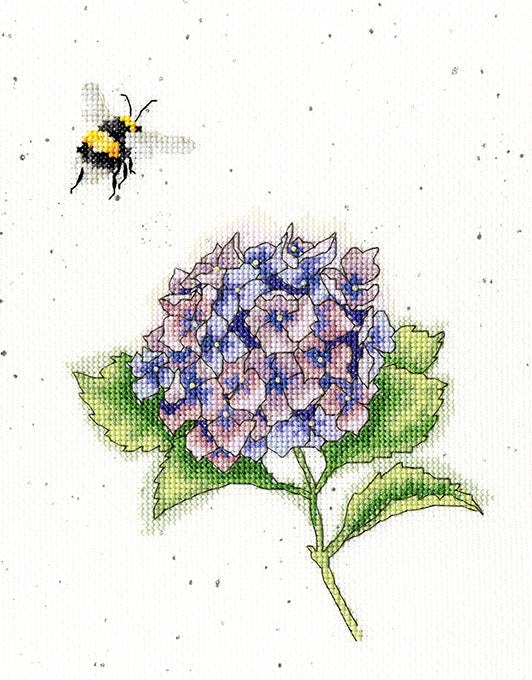 Cross stitch kit featuring a bumblebee and hydrangea design on speckled fabric