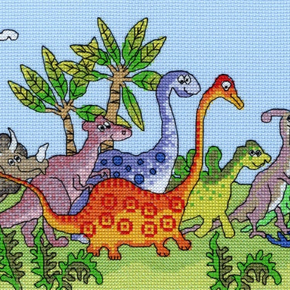 Colorful dinosaur-themed counted cross stitch design on blue Aida fabric from Dinosaur Fun Cross Stitch Kit by Bothy Threads