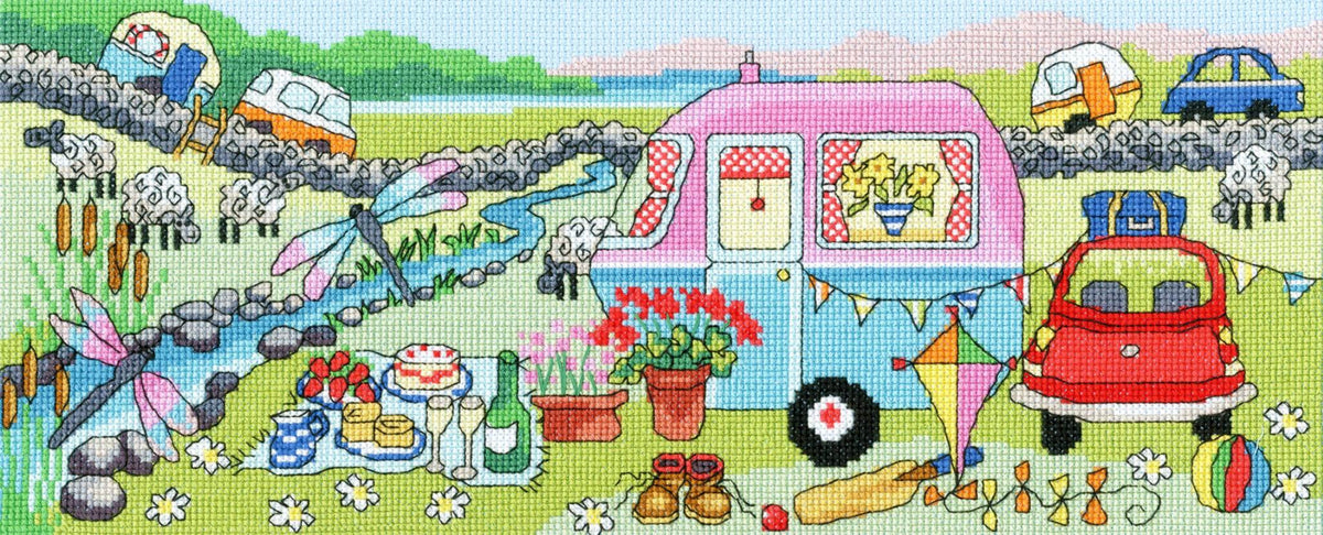 Caravan fun cross stitch kit featuring colorful caravan, picnic setup, dragonflies, sheep, and countryside scene