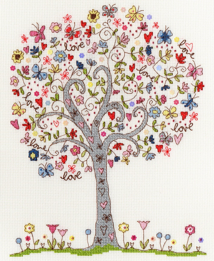 Colorful Love Tree cross stitch design with butterflies, flowers, hearts, and the word "love" on white Aida fabric