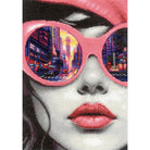 RIOLIS Big City Rhythm counted cross stitch kit showing a modern woman portrait with city street reflected in pink sunglasses
