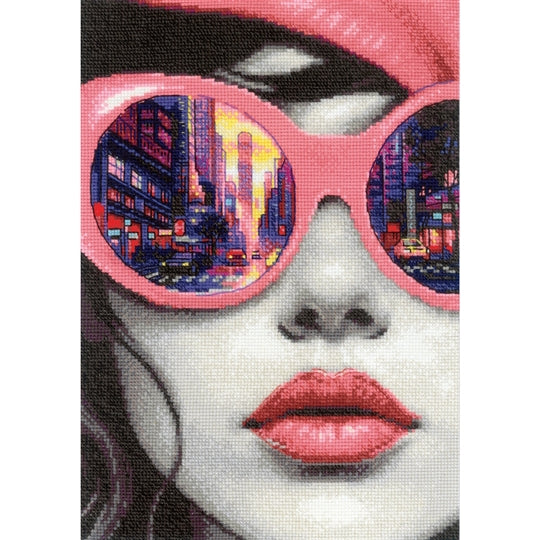 RIOLIS Big City Rhythm counted cross stitch kit showing a modern woman portrait with city street reflected in pink sunglasses
