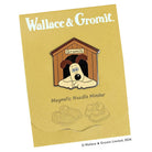 Magnetic needle minder with dog design holding needle and chart on fabric