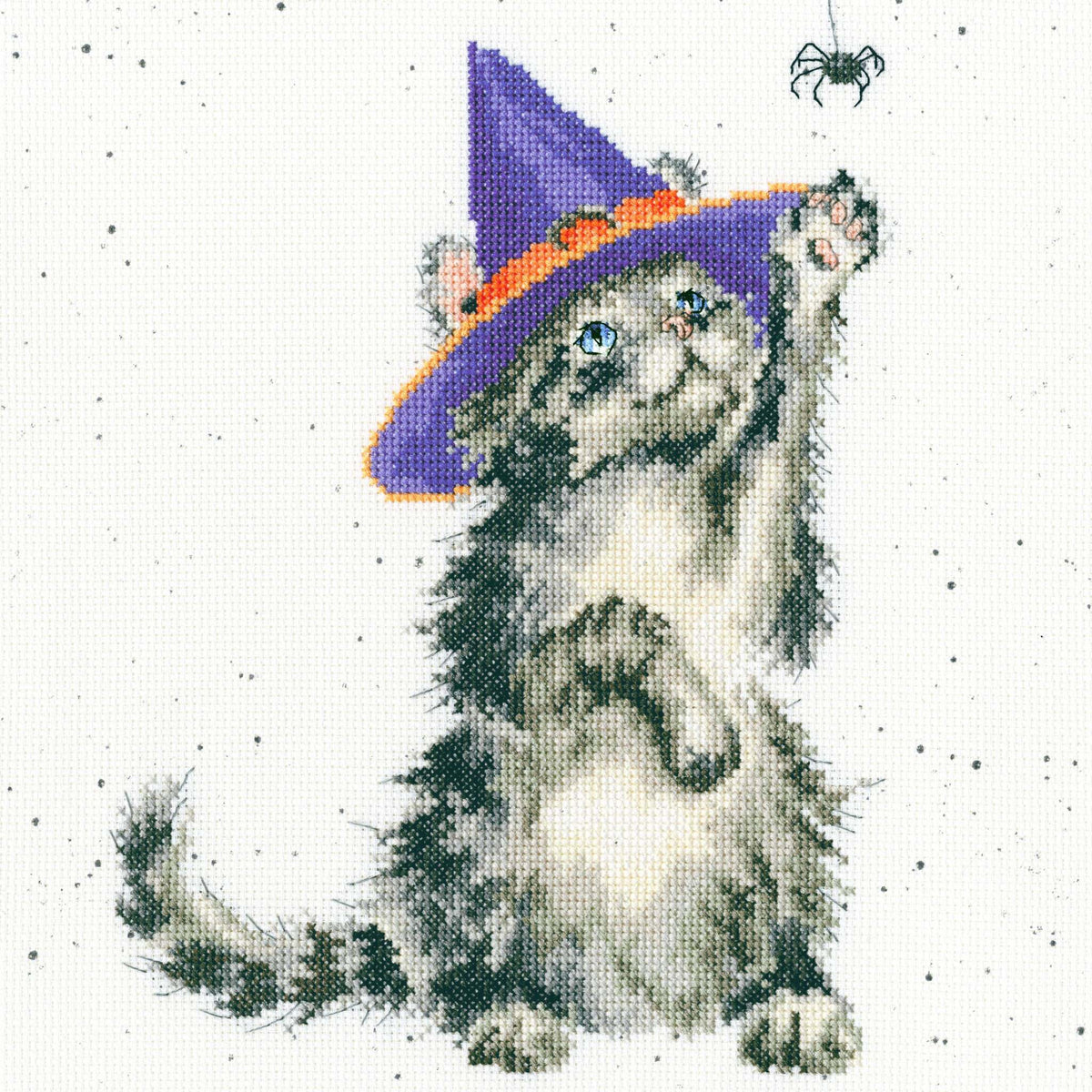 Cross stitched gray cat wearing purple witch hat reaching for hanging spider from The Witch's Cat Cross Stitch Kit